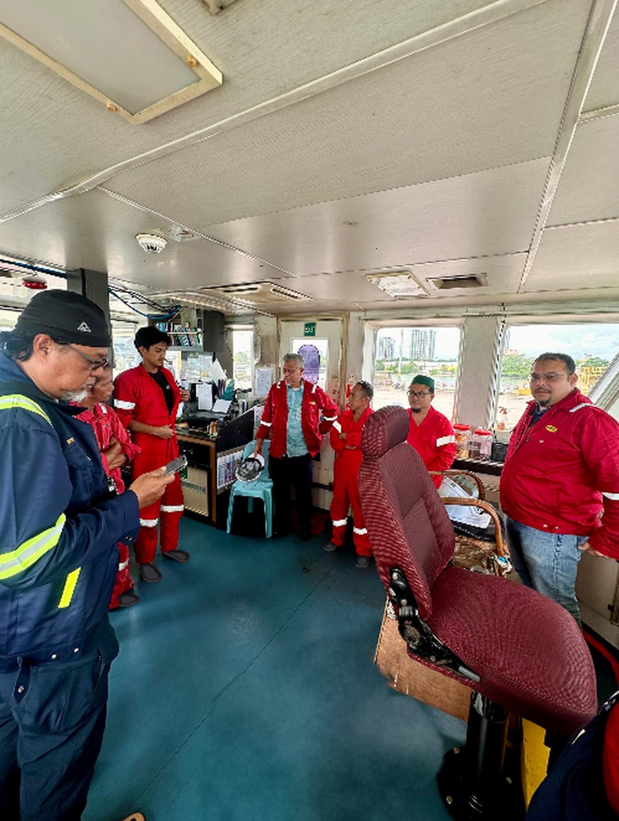 NESB management team on the bridge of a seismic support vessel, Penang Port